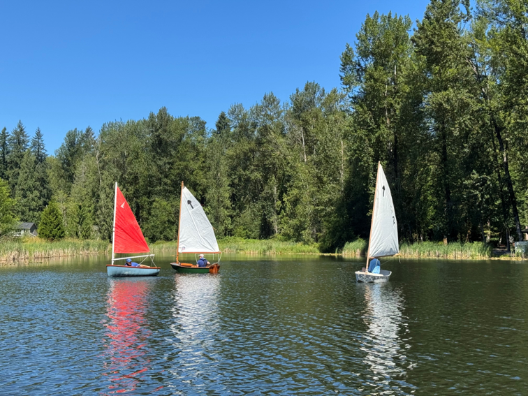 Three small sailboats on a lake. (Lake Marcel, Peter Templin)